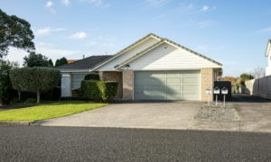 suburban garage with roller door under gabled roof
